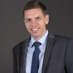 Man in suit with a blue tie.