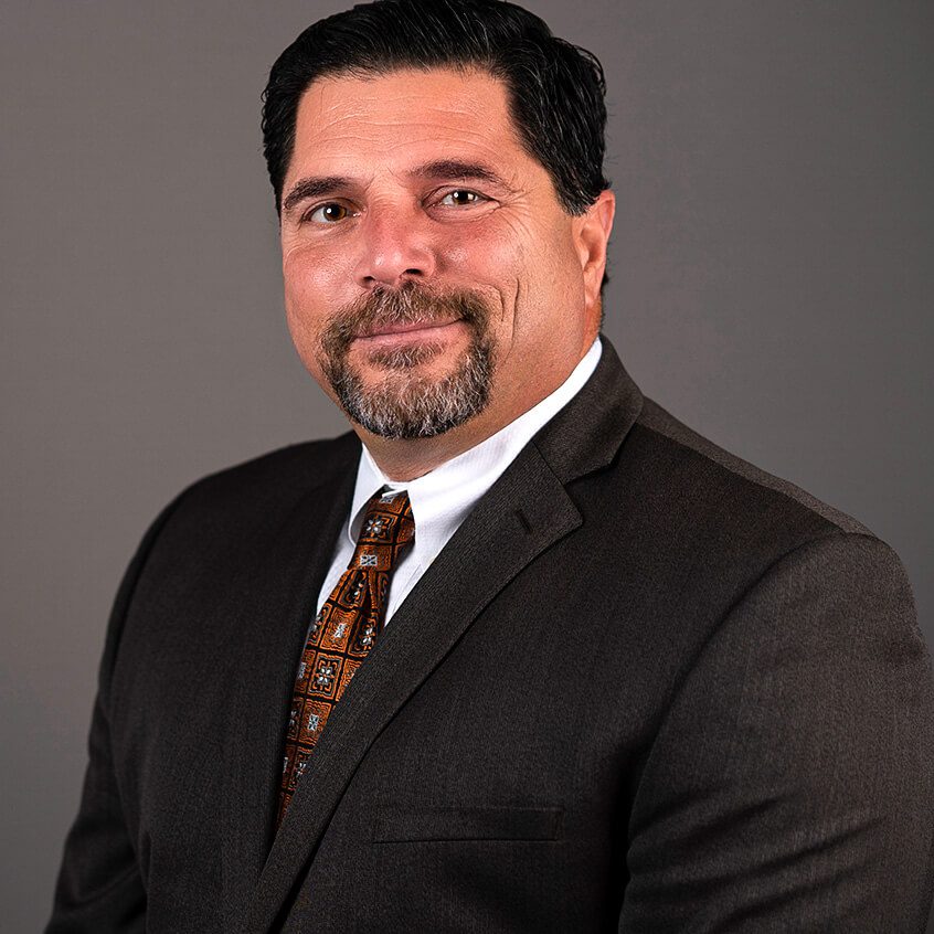 Man in a suit with a beard.