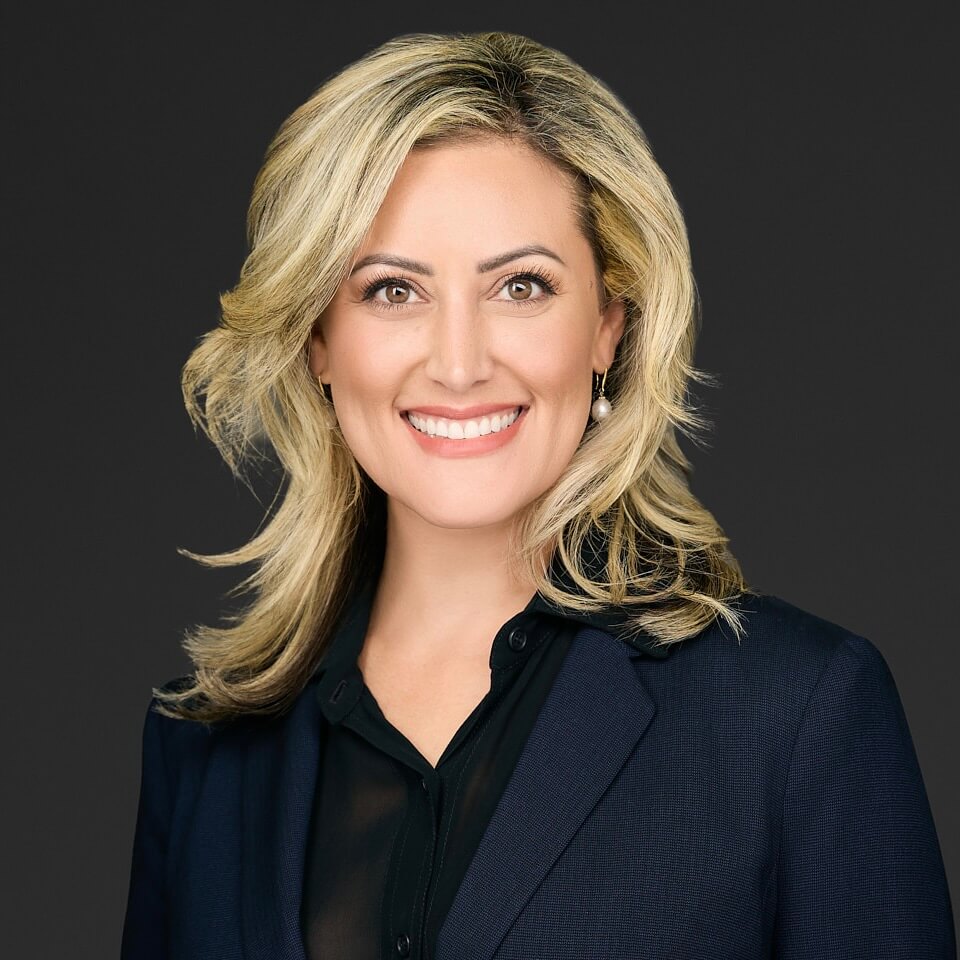 Professional woman with blonde hair in business attire.