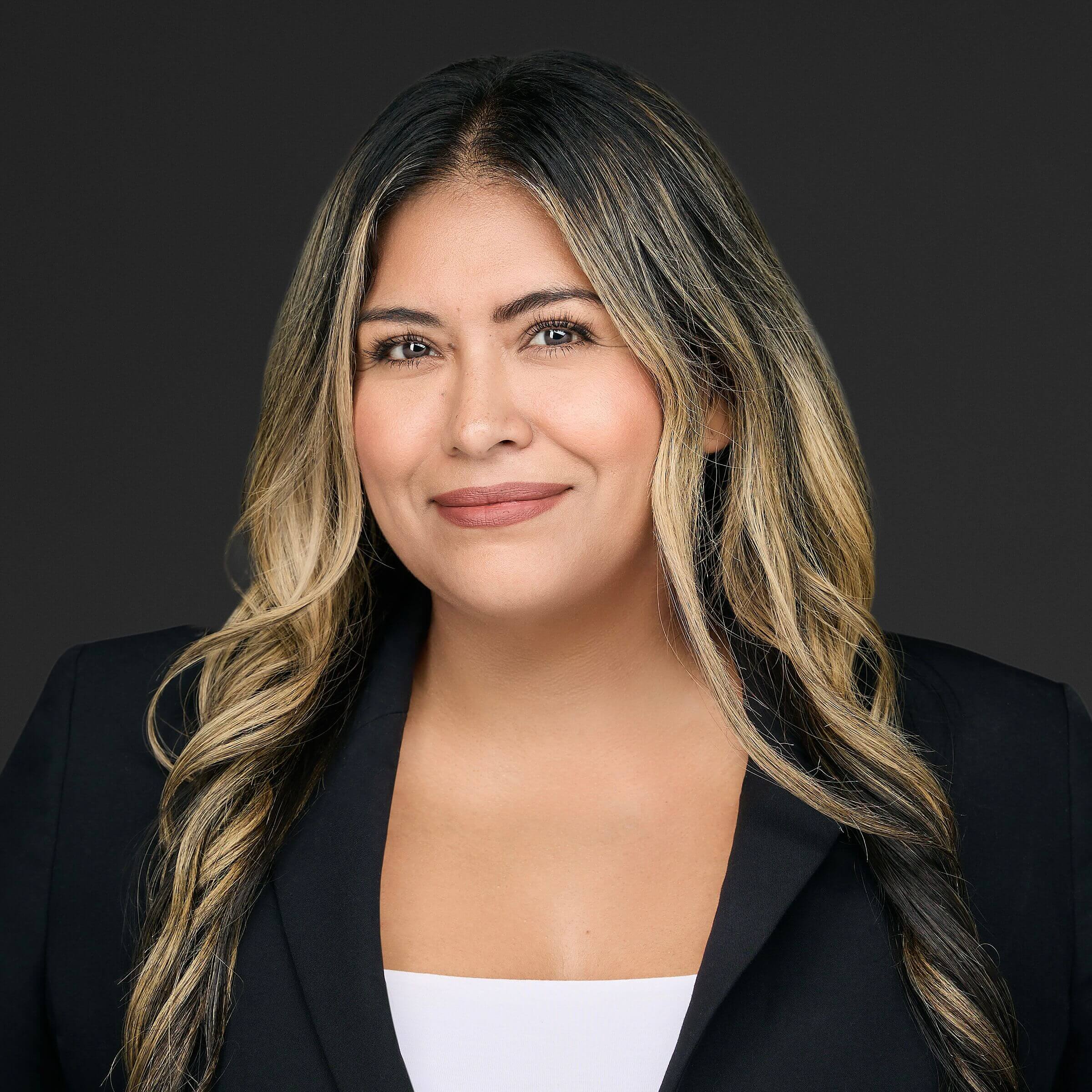 Professional woman with long blonde hair smiling.